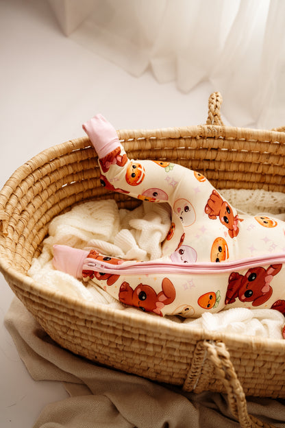 Close up of Pink Easter Bunny bamboo zip romper in woven bassinet
