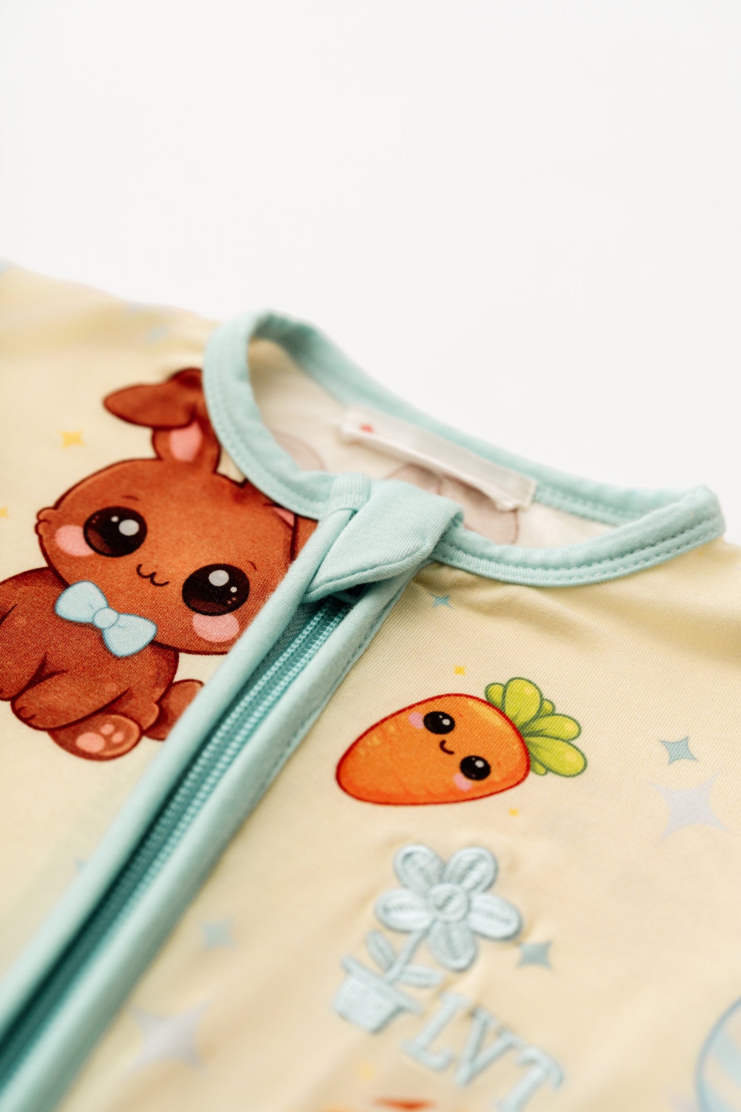 Close up of Blue Bunny bamboo zip romper neckline and zipper detail