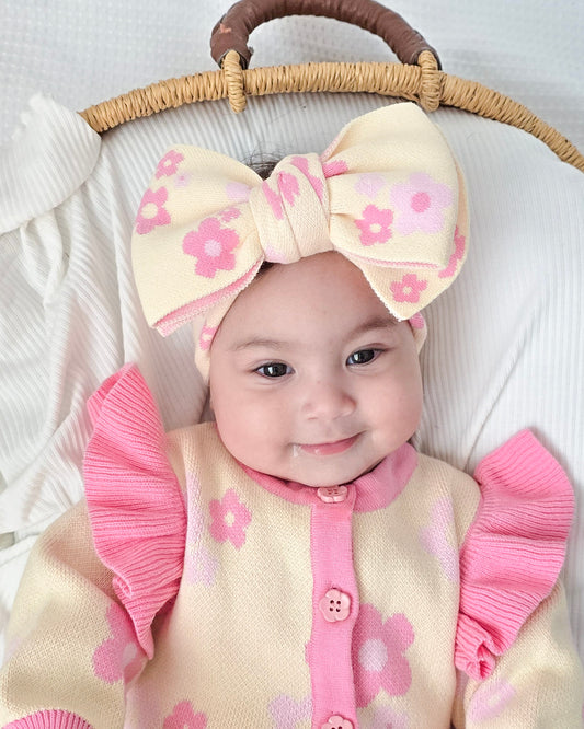 Baby girl wearing the Buttercup Princess floral bow headband by Little Violet Threads