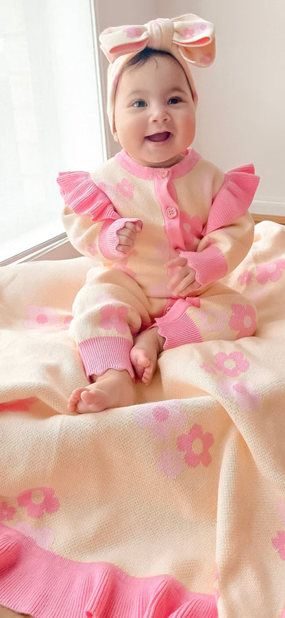Baby sitting on the Buttercup Princess floral knit blanket by Little Violet Threads.