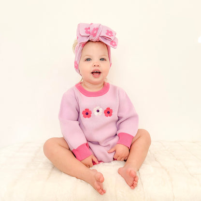 Baby girl wearing the La Dolce Lollie Blossom outfit with matching knitted headbow in soft purple and pink cotton knit