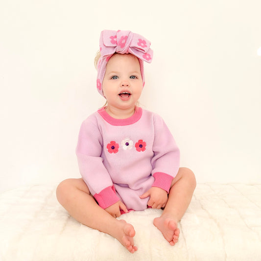Baby girl wearing the La Dolce Lollie Blossom outfit with matching knitted headbow in soft purple and pink cotton knit