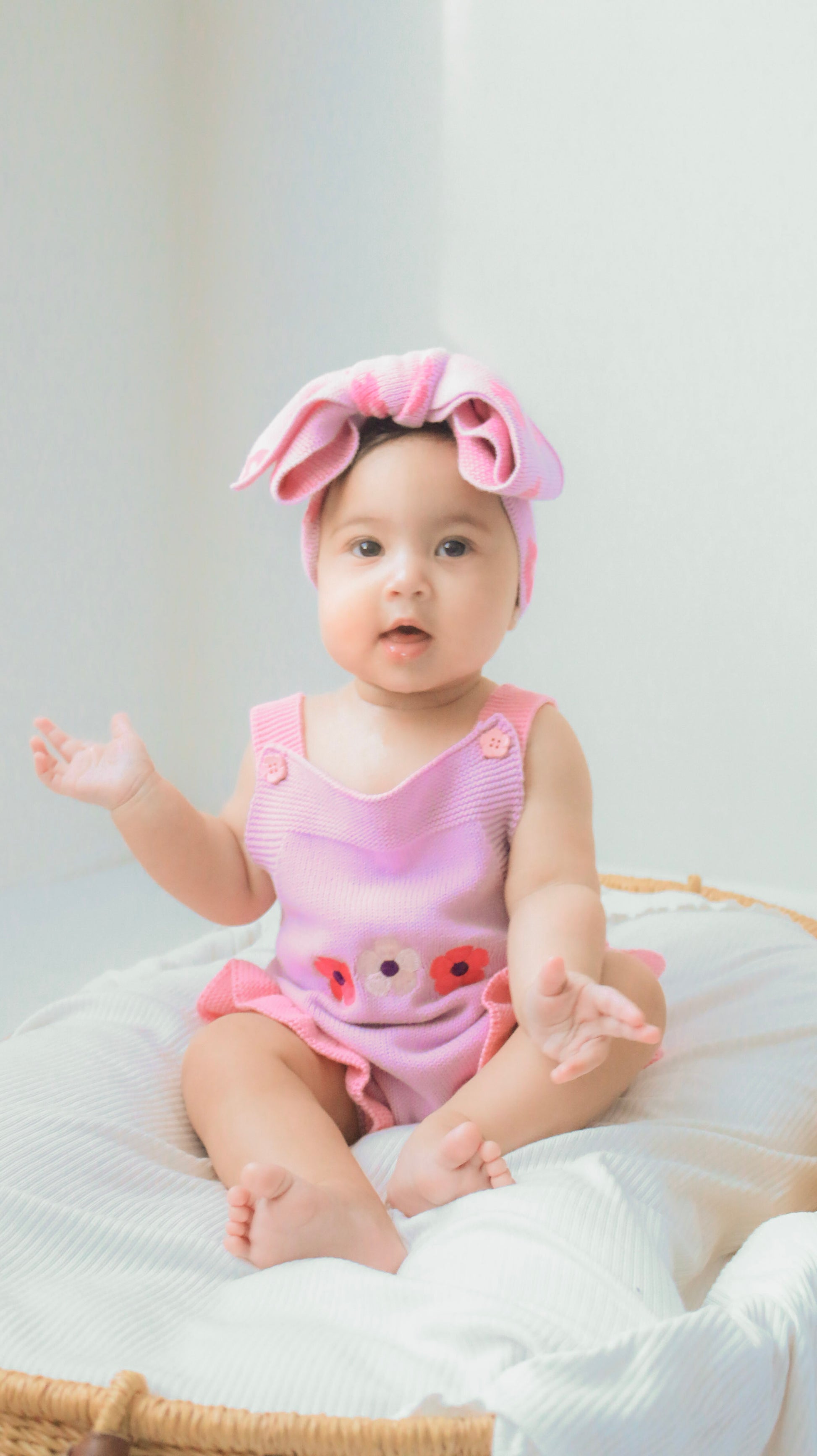 Baby girl wearing the La Dolce Lollie Blossom Romper in soft purple cotton knit with floral embroidery