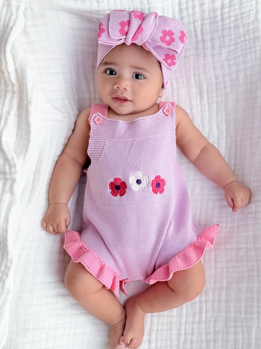 Baby girl wearing the La Dolce Lollie Blossom Romper in soft purple cotton knit with embroidered floral detailing