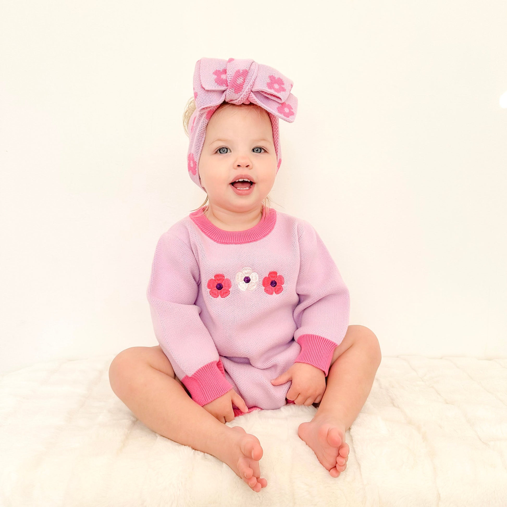 Baby girl wearing the La Dolce Lollie Blossom Romper with matching headbow by Little Violet Threads