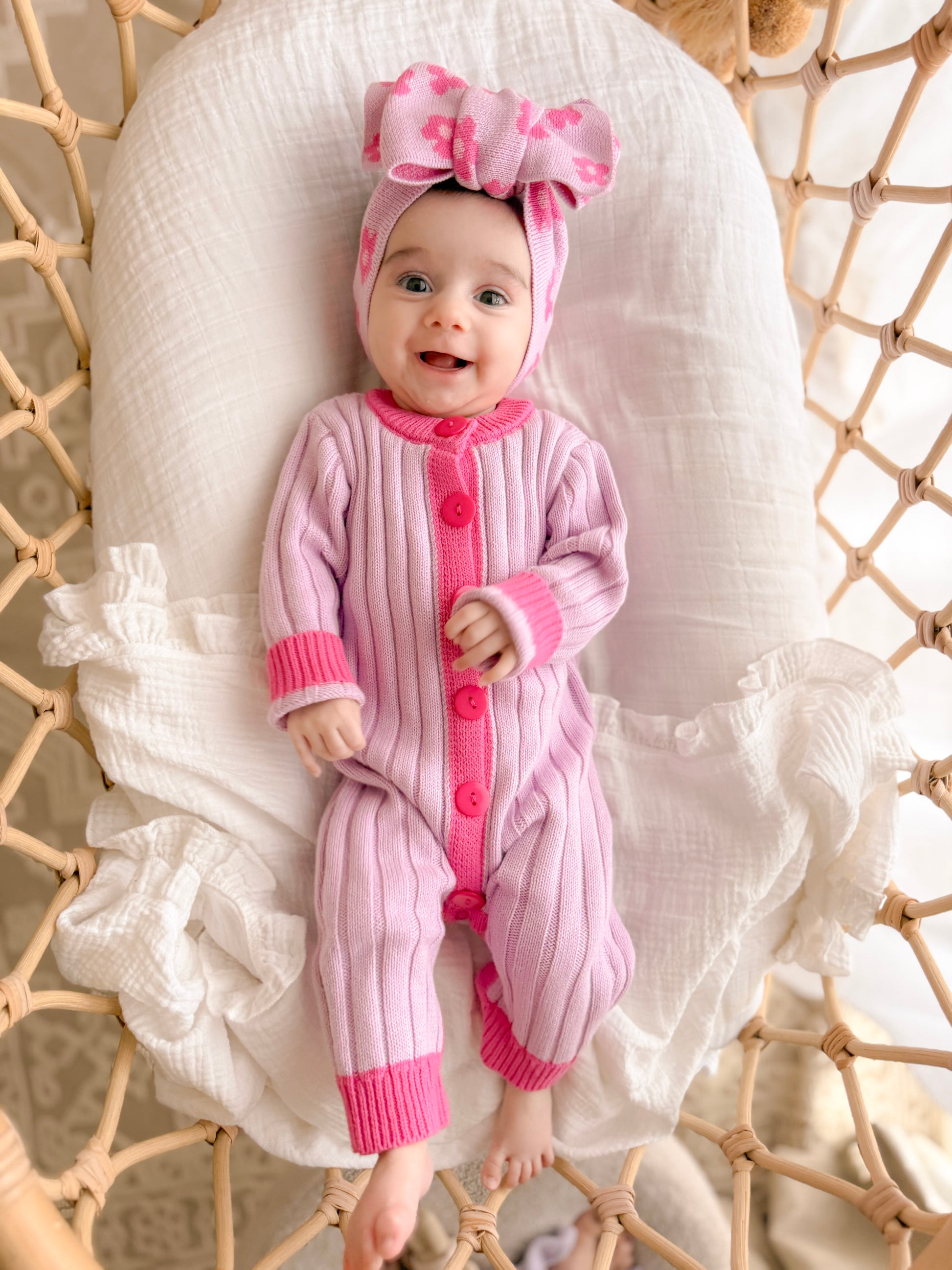 Baby girl wearing the La Dolce Lollie Dream Romper in purple and pink cotton knit