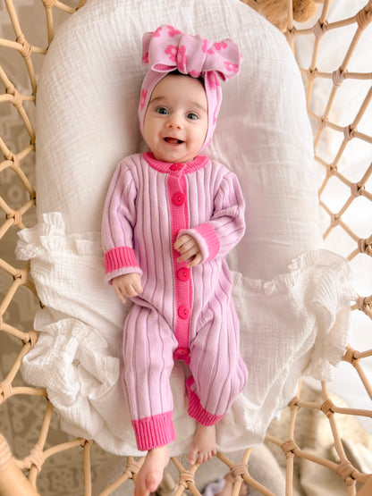 Baby girl wearing the La Dolce Lollie Dream Romper in purple and pink cotton knit