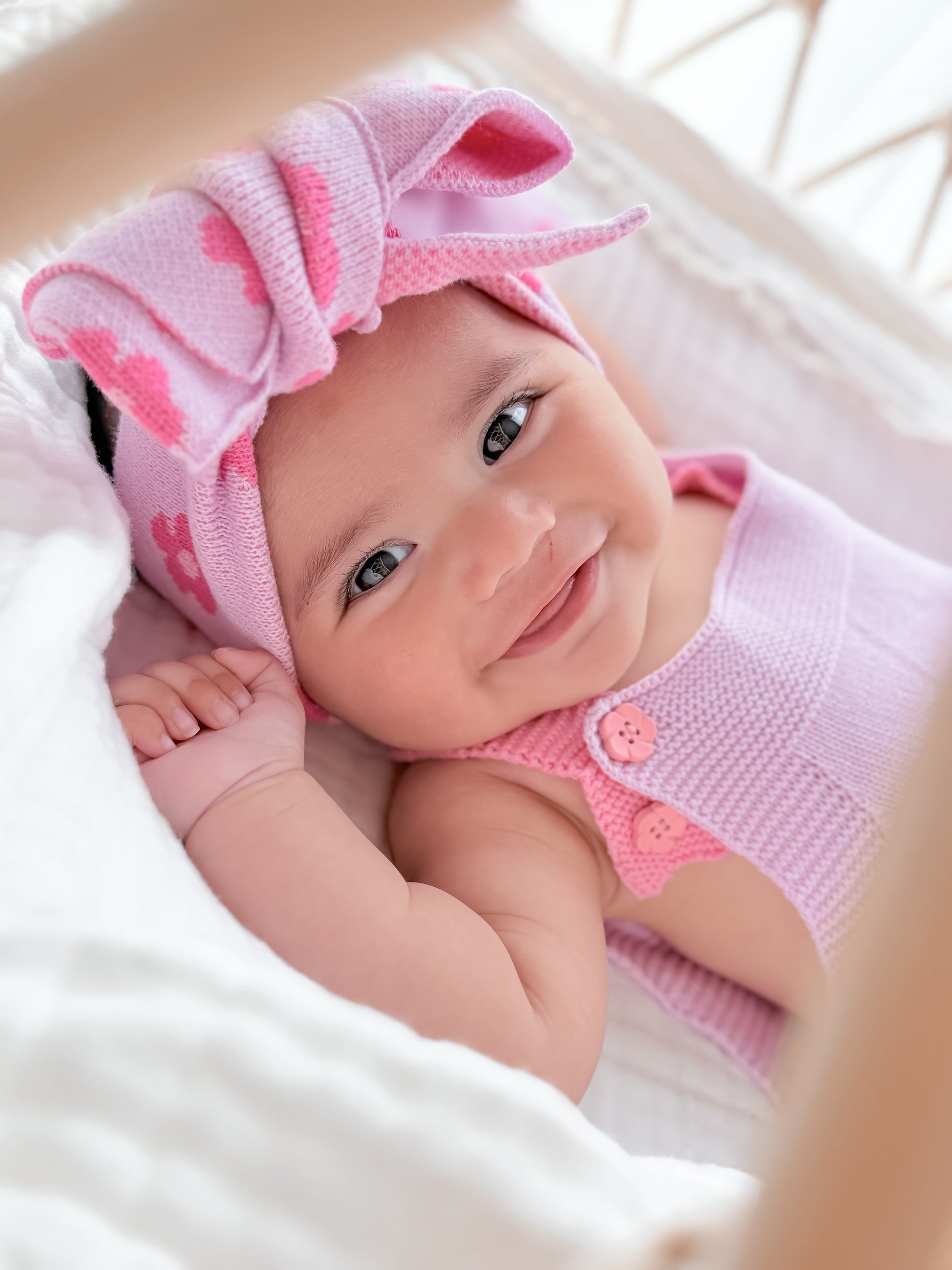 Baby wearing the La Dolce Lollie oversized knitted head bow in soft pink 100% cotton knit