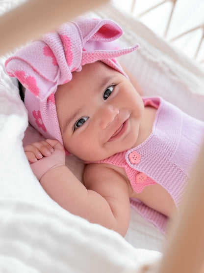 Baby wearing the La Dolce Lollie oversized knitted head bow in soft pink 100% cotton knit