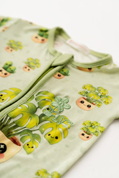 Children's outfit with plant-themed design on a light green background