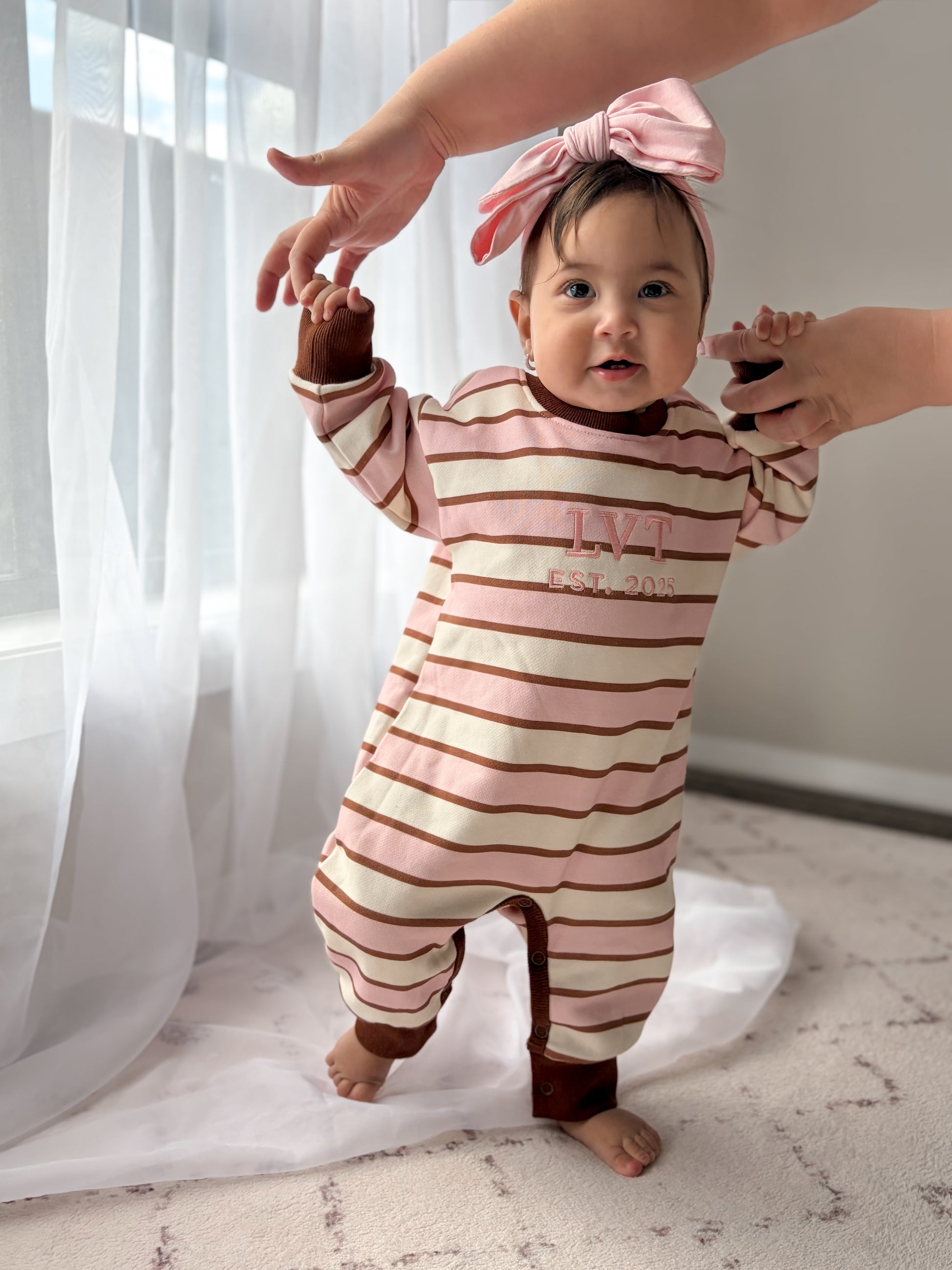 Neapolitan French Terry baby romper by Little Violet Threads in pink, cream and chocolate stripes with embroidered logo.