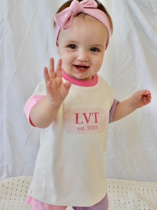 Toddler girl wearing Little Violet Threads Pastel Dreams baby lounge set with oversized tee and pastel colour block shorts
