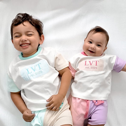 Brother and baby sister wearing matching Little Violet Threads pastel lounge sets with oversized cotton tees and colour block shorts
