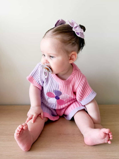 Baby wearing the Little Violet Threads Petal Knit Set from the La Dolce Lollie collection in pink and lilac floral knit design