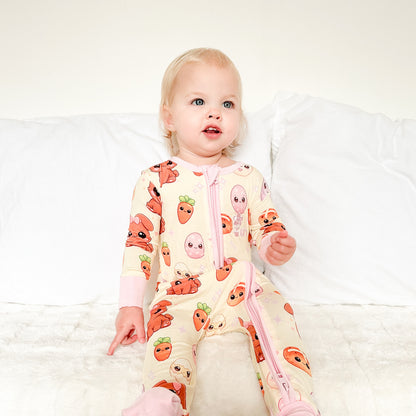 Toddler wearing Pink Bunny bamboo baby zippy romper sitting indoors