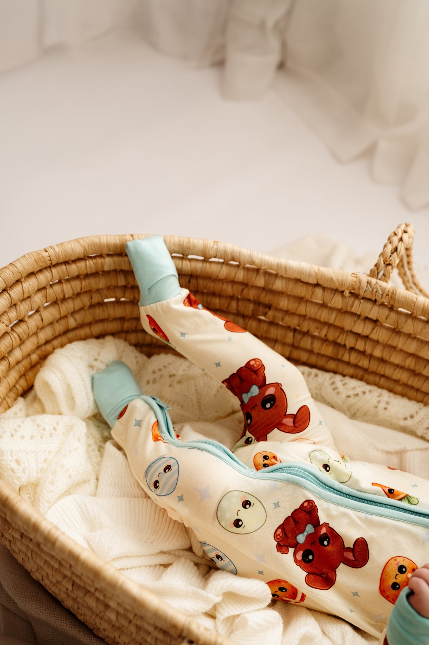 Baby feet up in woven bassinet wearing Blue Bunny bamboo zip romper