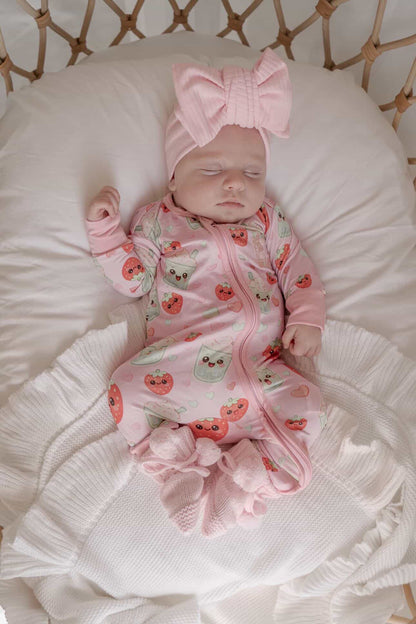Sleeping newborn wearing Strawberry Matcha bamboo baby zippy romper