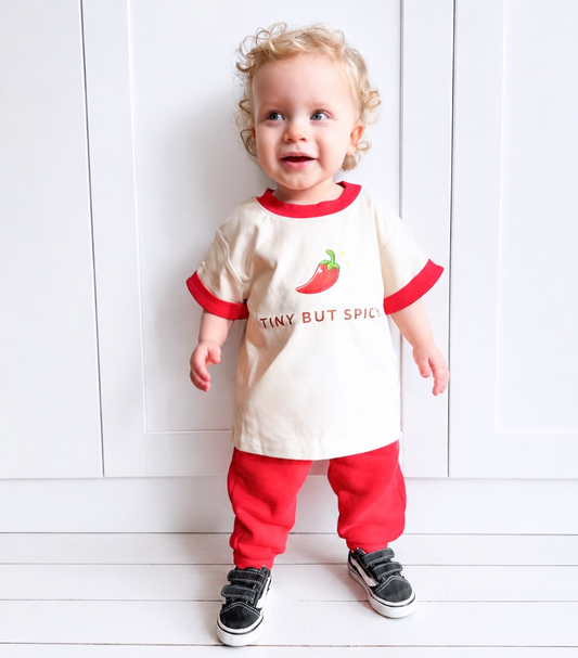 toddler wearing little violet threads tiny but spicy oversized tee with matching red pants